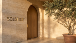 Solstice med spa entrance with travertine facade and brass signage
