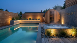 Caldera backyard wellness retreat with pool, sauna and jacuzzi at dusk