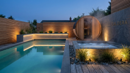 Caldera backyard wellness retreat with pool, sauna and jacuzzi at dusk