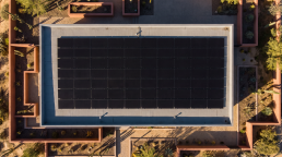 Aerial view of a Helios solar array on a modern roof at golden hour